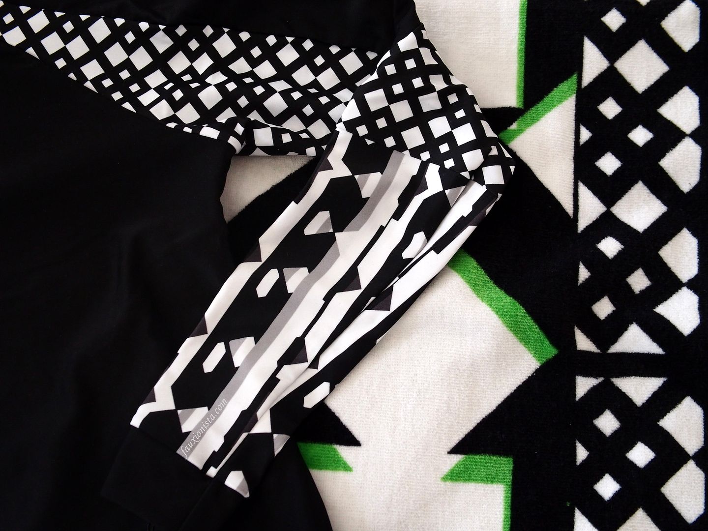 Close up detail of rash guard and beach towel