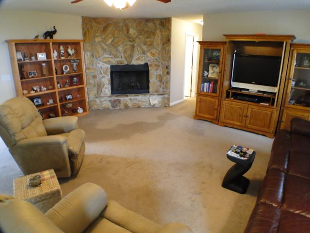 A very cozy living room welcomes you with a large stone gas log fireplace, 3 bedroom home for sale in Franklin NC, Single level home for sale in the mountains 