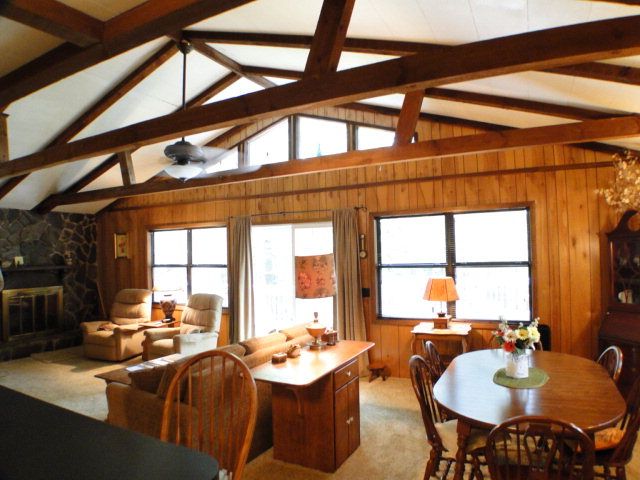The living room has vaulted ceilings with wood beam accents, Log Cabin for Sale in Cullowhee NC