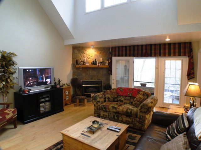 The living room has a gorgeous vaulted ceiling with large window letting lots of light in from the second floor, Upscale Home for Sale in Franklin NC