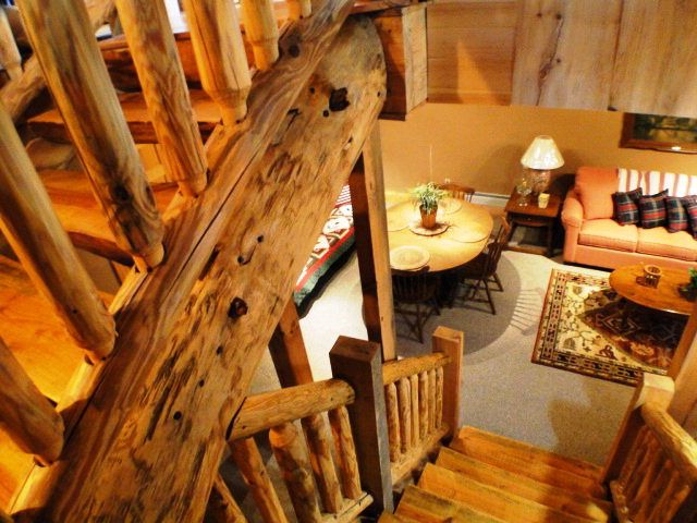Another gorgeous staircase leads you downstairs to the cozy family room, Upscale Log Cabins for Sale in Franklin