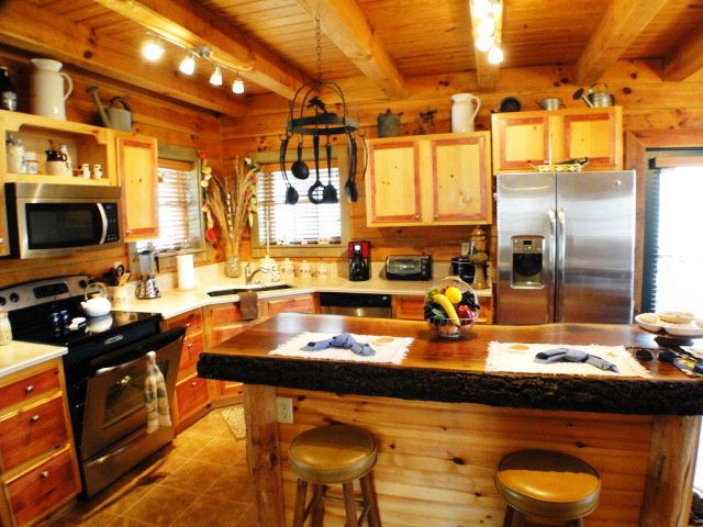 Everything you'd expect to find in an upscale log cabin kitchen, cutsom log kitchen island and more, Franklin NC Homes for Sale