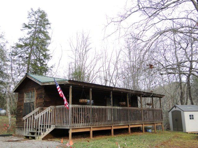 This home is VERY cute and features vaulted ceilings beautiful log walls and floors two ceiling fans with lights double sliding glass doors to deck, Franklin NC Singlewide for Sale