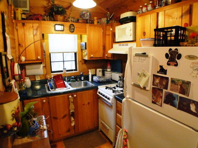 The kitchen features beautiful wood cabinets with stove refrigerator and microwave. Park Model for Sale in Franklin NC 