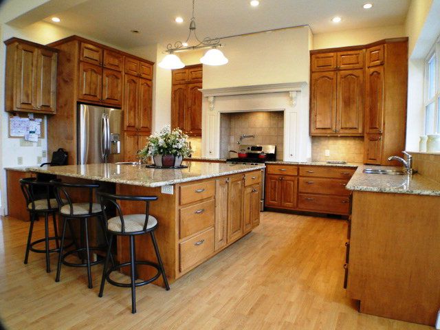 Custom maple cabinets granite countertops stainless steel appliances prep sink faucet over stove and much more in this goumet kitchen in Franklin NC, Bald Head Realty