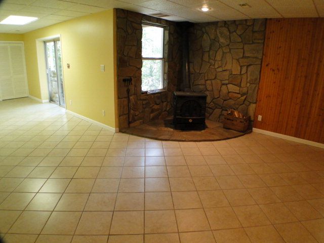 Downstairs you'll find a wood stove and tile flooring, Homes for Sale in Franklin NC with Wood Stoves