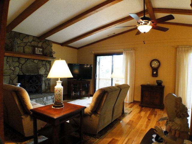 This living room is truly gorgeous with vaulted ceiling stone fireplace and stylish hardwood floors, Franklin NC Home for Sale