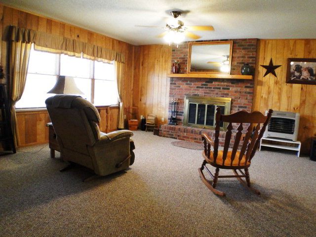 The cozy living room has a lovely wood-burning fireplace… sit by the fire and read a book, Lovely Home for Sale in Franklin NC