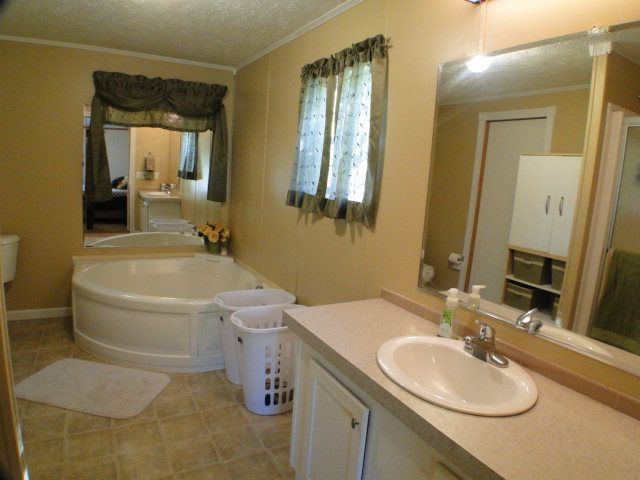 The large master suite features a really neat waterfall garden tub in addition to the walk-in shower, Franklin NC Homes for Sale in Cartoogechaye Area
