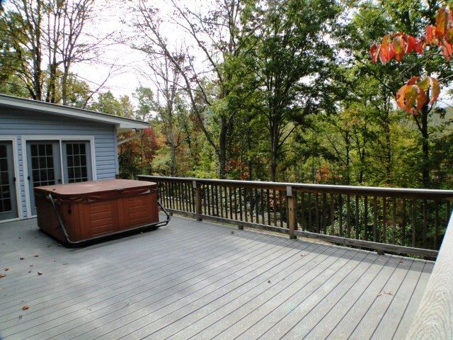 There is a large deck for entertaining PLUS a jumbo enclosed sun porch, Keller Williams Franklin NC, Macon County Homes for Sale