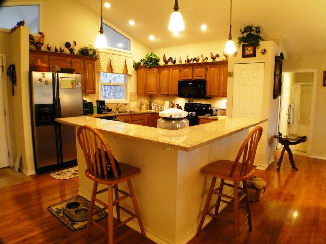 An open country kitchen with granite counters and a breakfast bar is the center of this lovely home for sale in Franklin NC, Macon County Homes for Sale