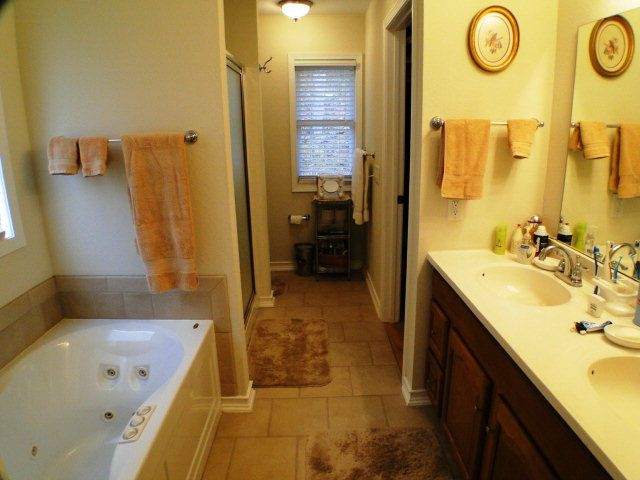 A dual-control jetted bathtub to wash away your cares highlights this master bathroom suite in Franklin NC, Homes for Sale in Franklin NC, John Becker Bald Head