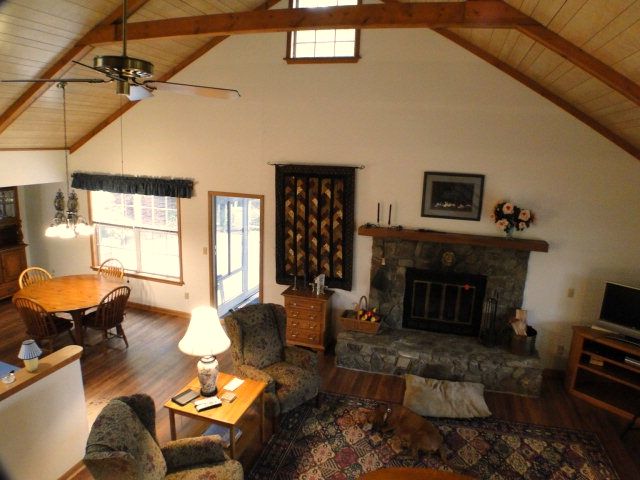 Vaulted and beamed ceilings highlight the open living room in this Macon County Home for Sale