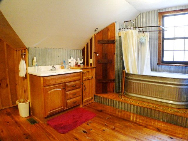 Imagine soaking in this custom watering-trough bathtub, 840 Sanders Road Franklin NC, Log Home for Sale with Acreage